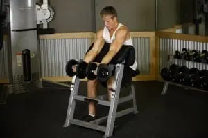 the Lifting of the dumbbells on a biceps on the Scott bench