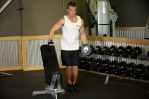 Lifting dumbbells with one hand in the direction of