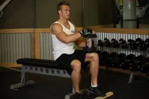 the donkey raises with dumbbells sitting