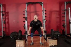 the rise of the bar to the chest using blocks (stands)