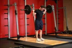 Alternating rise on the heels and on your toes with a barbell