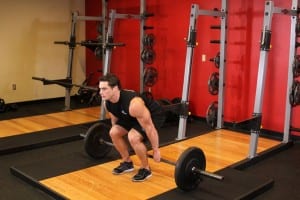 Squats with barbell behind back