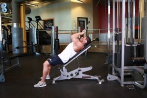 Extension of the triceps on the upper block lying on an inclined bench