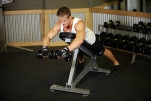 Breeding of dumbbells c rotation lying on a flat bench