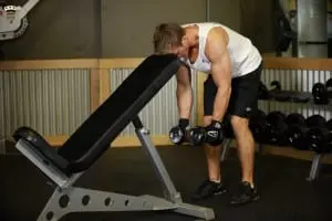 Breeding hands with dumbbells in focus