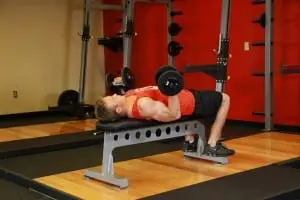 the Bending of the arms at the biceps with dumbbells lying down