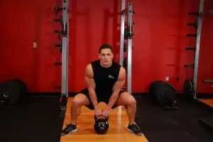 Pull weights to the breast in the Sumo style