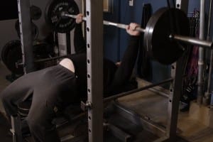 Bench press bar in the power frame with resistance bands