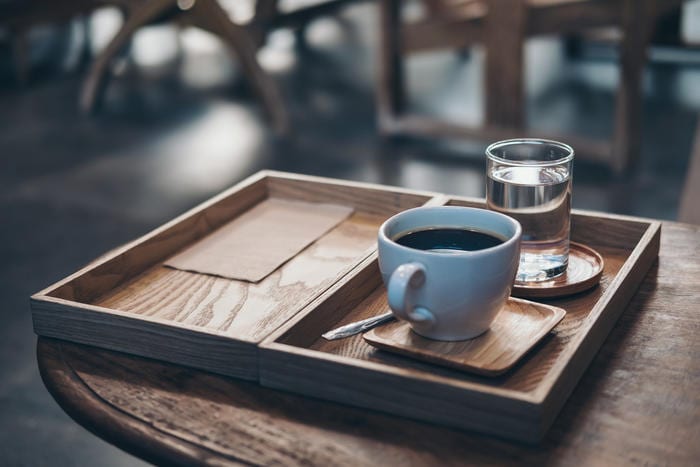Why coffee is served with a glass of water?