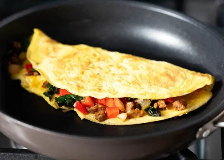 Omelette recipe mixed with meat products. Calorie, chemical composition and nutritional value.