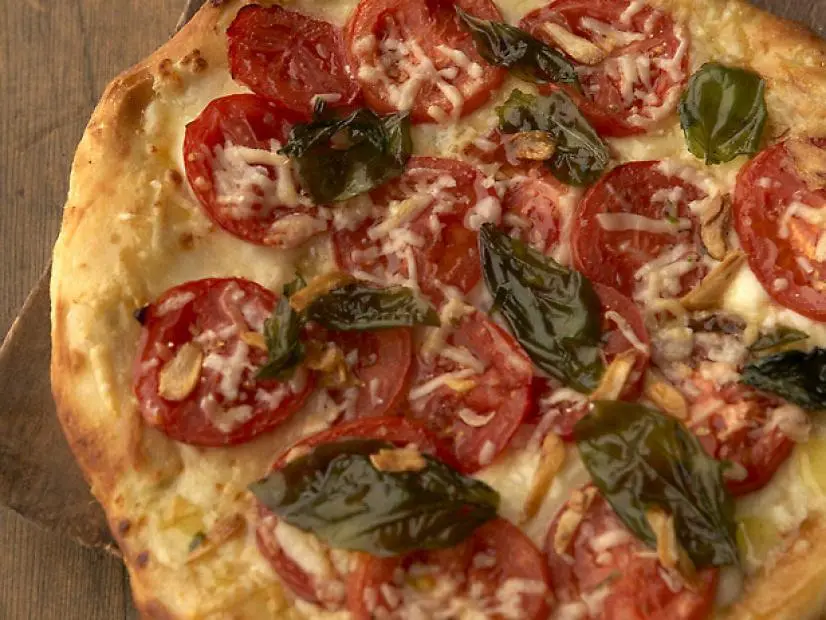 Recipe for Pizza with Tomatoes and Cheese. Calorie, chemical composition and nutritional value.