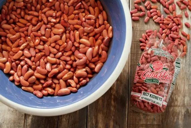 Should the water be drained when boiling beans?