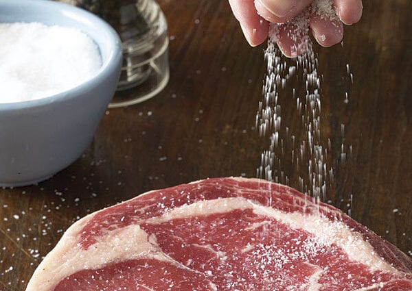 When to salt meat when cooking?