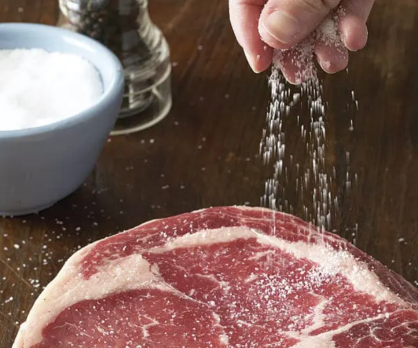 When to salt meat when cooking?