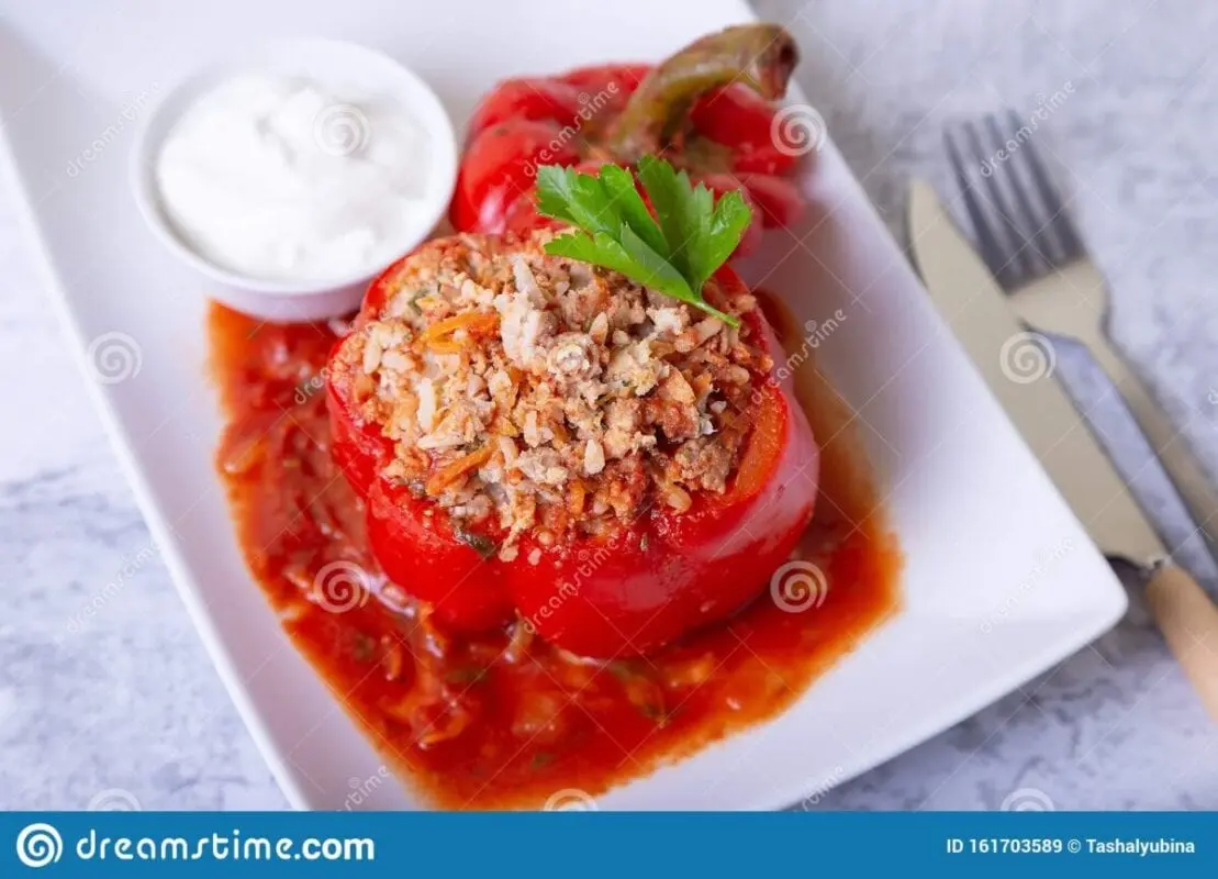 Pepper stuffed beef. with sour cream and tomatoes