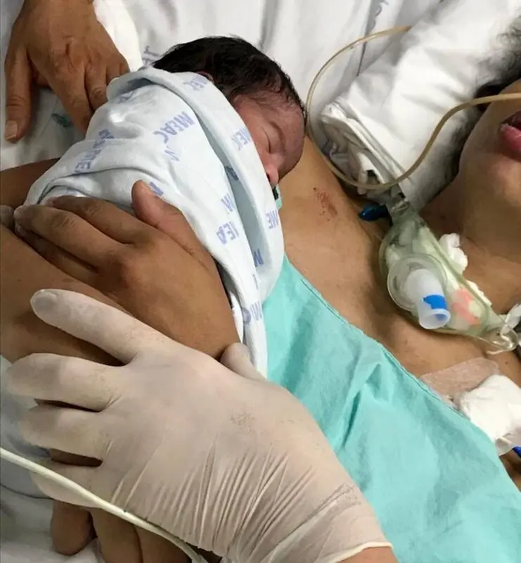 A woman wakes up from a coma when her newborn baby is put on her chest