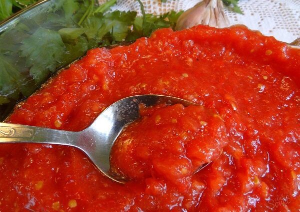 Adjika from tomatoes: a recipe for the winter with garlic without cooking and with cooking. Video