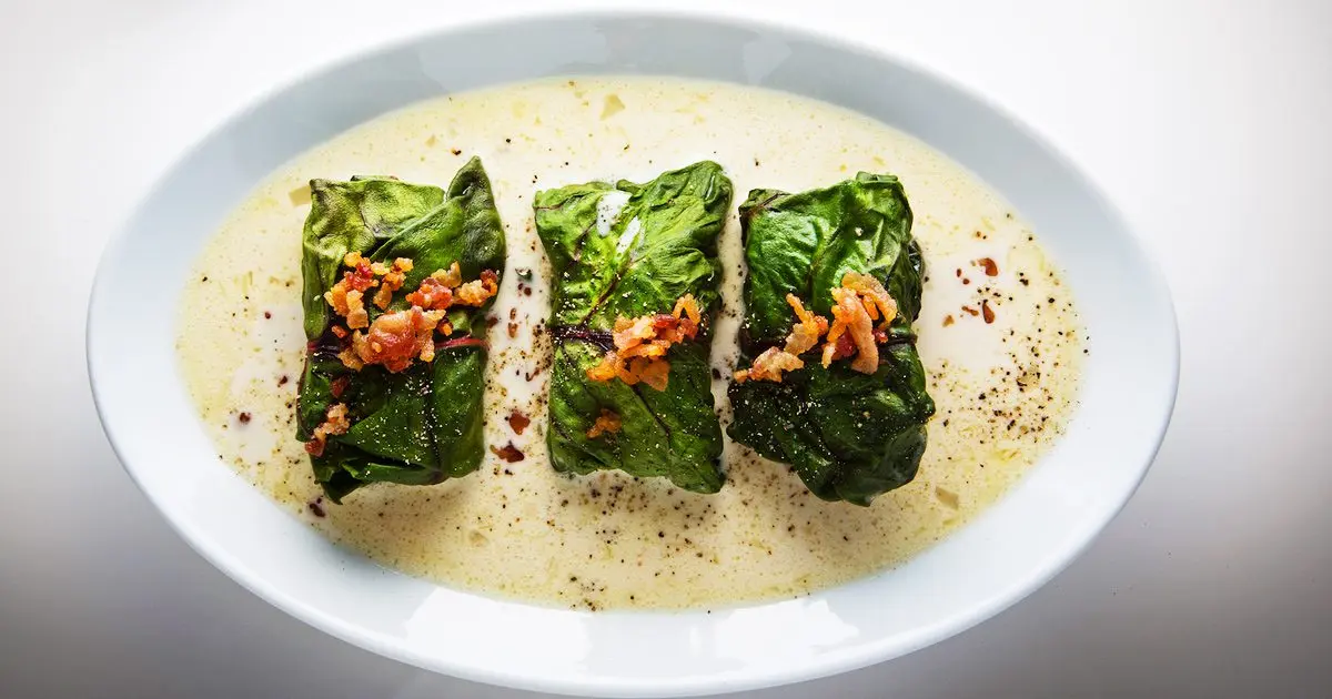 Dumplings stuffed with chard leaves in chives broth