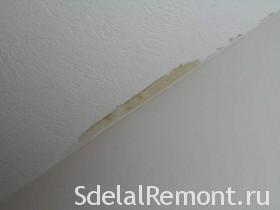 How can yellow stains on the ceiling be removed after flooding?