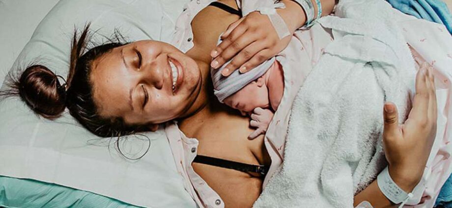 Partner childbirth: a man burst into tears, looking at his wife in the hospital &#8211; real photo