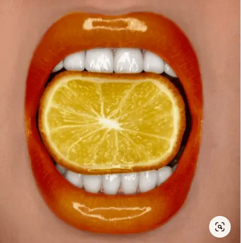 Vibrant paint colors: orange lips, lemon eyes, green nails