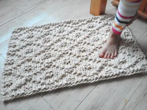 Knitted rug handmade from yarn