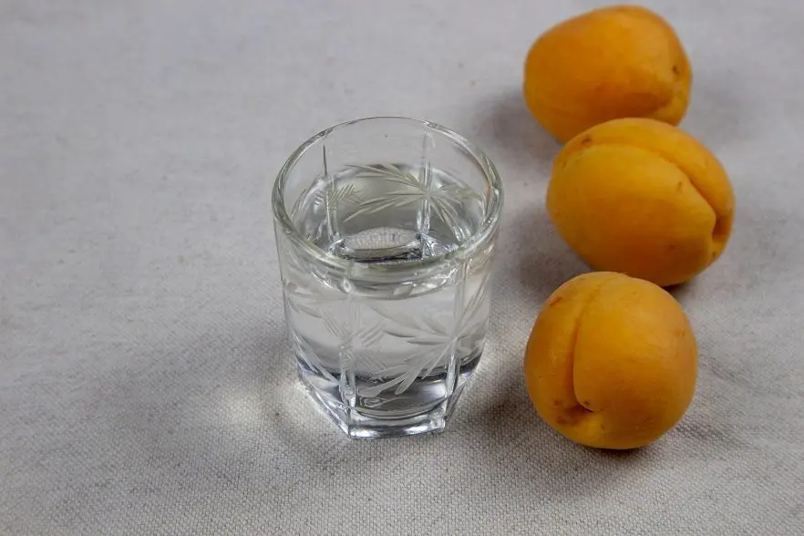 Homemade apricot brandy aged in barrel or oak chips