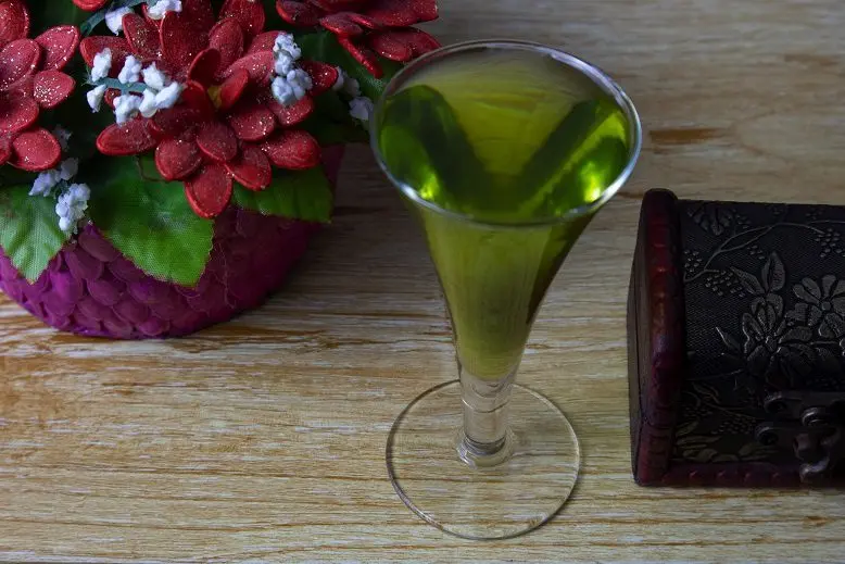 Homemade basil liqueur with zest and spices