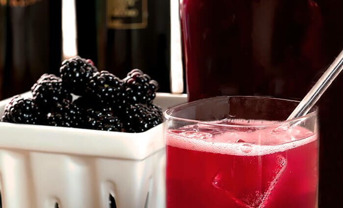 Homemade blackberry liqueur with lemon zest