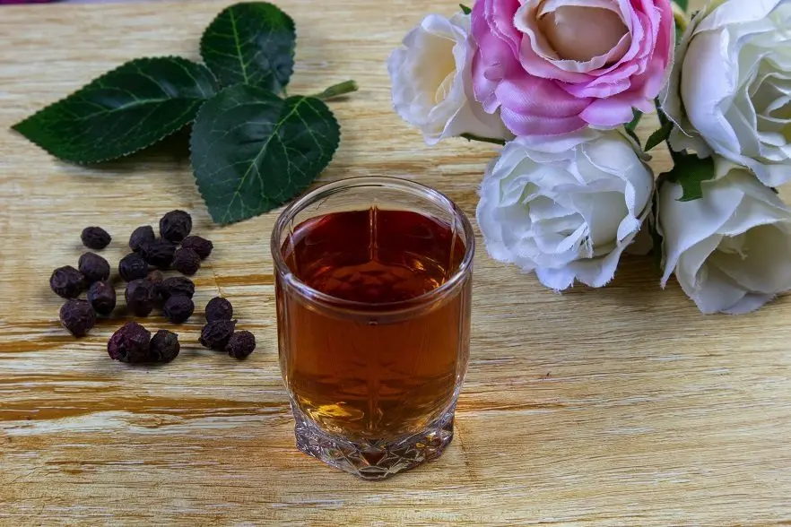 Pouring hawthorn berries on vodka