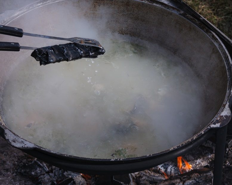 Real fisherman&#8217;s soup with vodka on a stove or fire