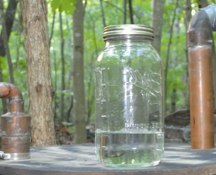 We clean moonshine with potassium permanganate using a simple method