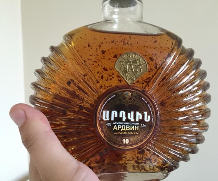 Why does a precipitate appear in cognac (grape brandy)