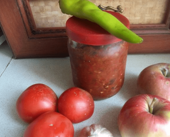 Adjika with tomatoes, peppers and apples 