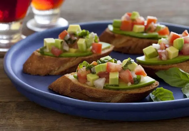 Bruschetta with avocado and shrimps, fish, crab, egg