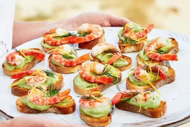 Bruschetta with avocado and shrimps, fish, crab, egg