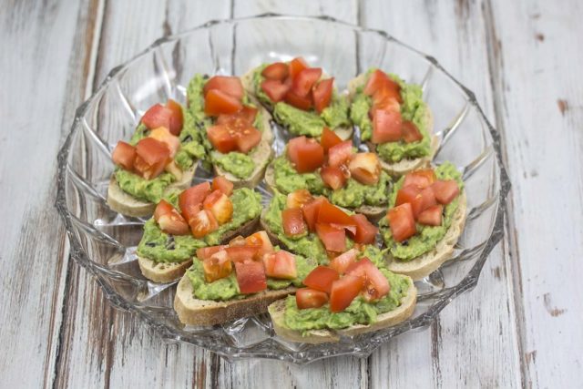 Bruschetta with avocado and shrimps, fish, crab, egg