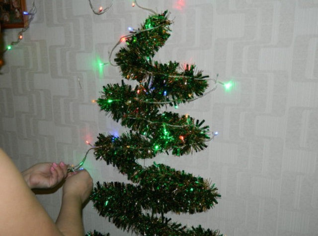 Christmas tree made of garlands and tinsel: on the wall with your own hands, from sweets, cardboard, wire