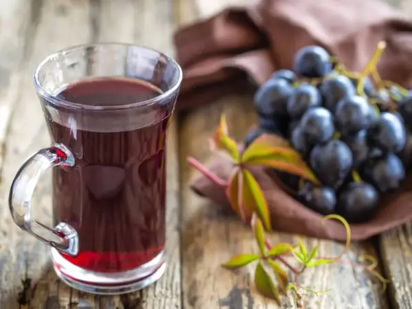 Grape juice for the winter at home through a juicer, juicer or manual extraction
