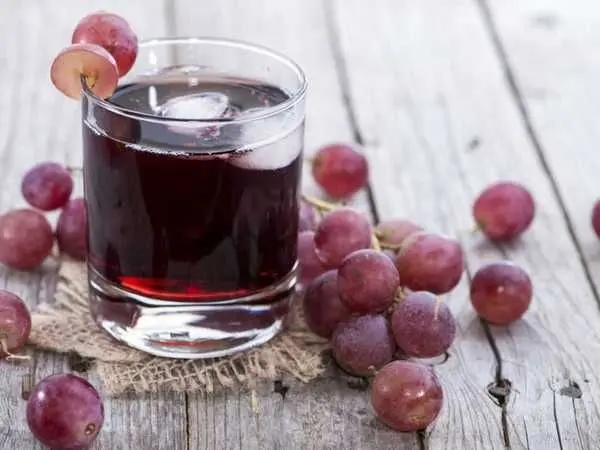 Grape juice for the winter at home through a juicer, juicer or manual extraction