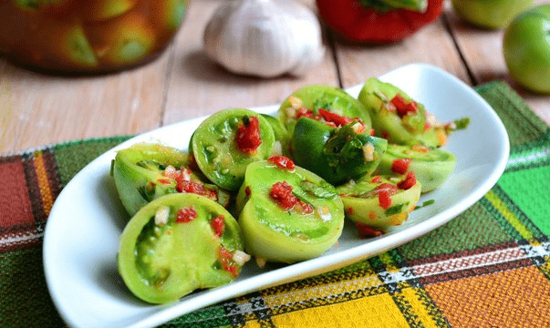 Harvesting green tomatoes for the winter in jars 