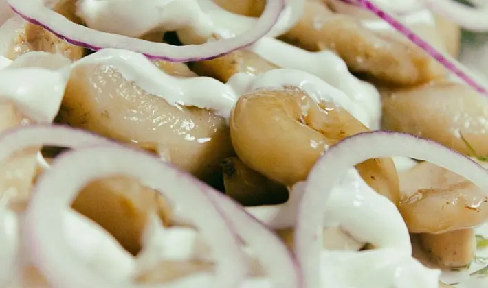 Hot salted mushrooms in jars and barrels