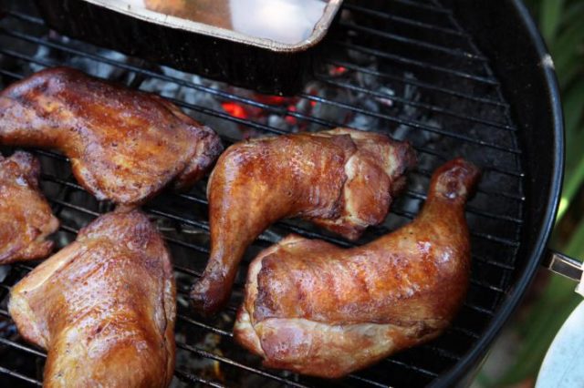 Hot smoked chicken legs in a smokehouse at home