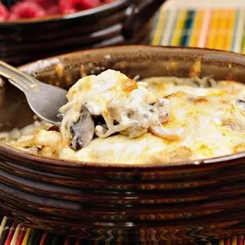 Julienne with mushrooms and cheese in the oven and in a frying pan