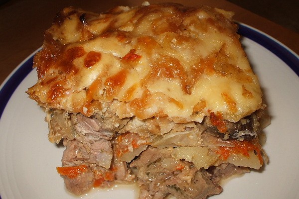 Meat with mushrooms baked in the oven or slow cooker