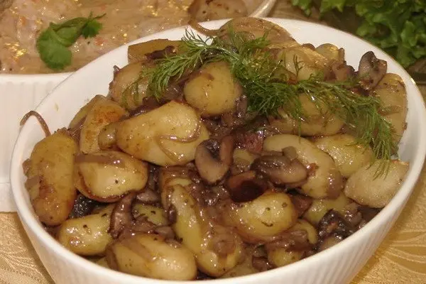 Meat with mushrooms baked in the oven or slow cooker