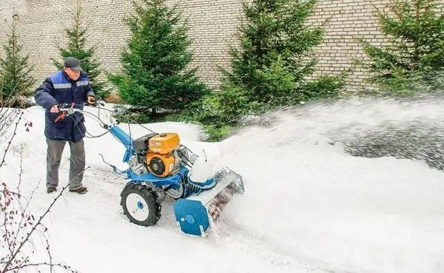 Mounted snow blower on a walk-behind tractor