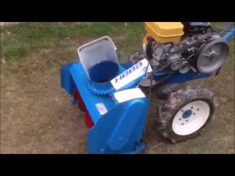 Mounted snow blower on a walk-behind tractor