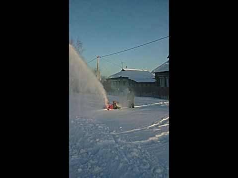 Mounted snow blower on a walk-behind tractor