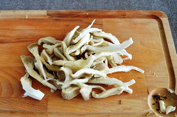 Oyster mushrooms in sour cream in a pan and in the oven: with onions, potatoes, pork